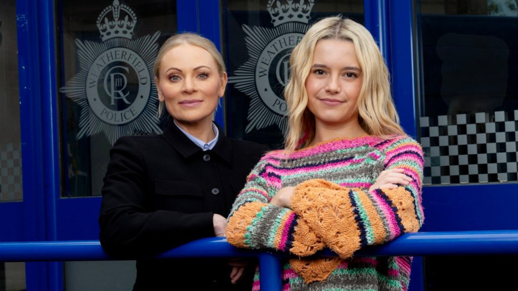 A promo image of Vicky Myers and Sydney Martin as Lisa and Betsy Swain standing out side Weatherfield Police Station