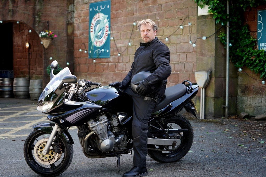 Dave sits on his motobike in Hollyoaks village